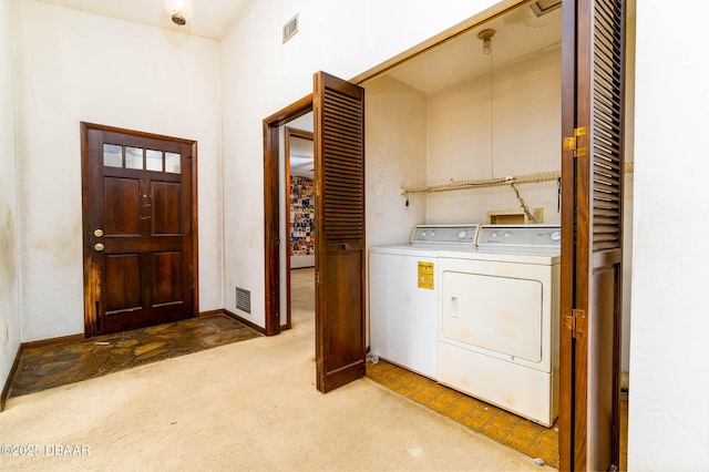 laundry area with baseboards, laundry area, carpet flooring, and washer and clothes dryer