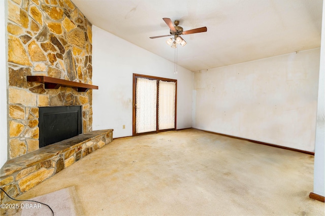 unfurnished living room with carpet floors, a stone fireplace, a ceiling fan, baseboards, and vaulted ceiling