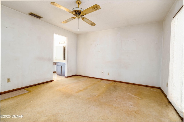 unfurnished room with visible vents, a ceiling fan, baseboards, and light colored carpet
