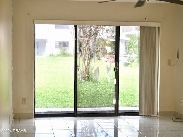 1508 Virginia Ave Unit 103, Daytona Beach, FL 32114 - doorway with plenty of natural light, tile patterned floors, ceiling fan, and baseboards