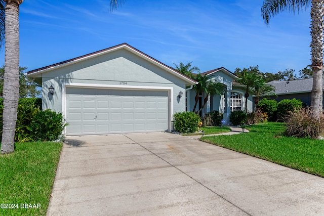 ranch-style home with a garage and a front yard