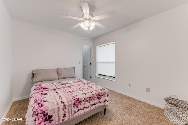 bedroom featuring ceiling fan and carpet