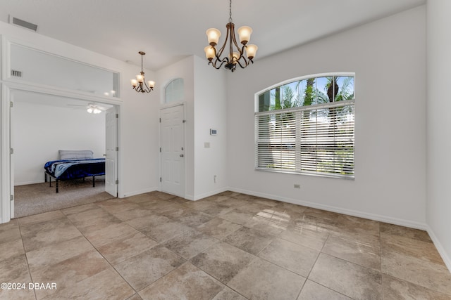 foyer featuring ceiling fan with notable chandelier