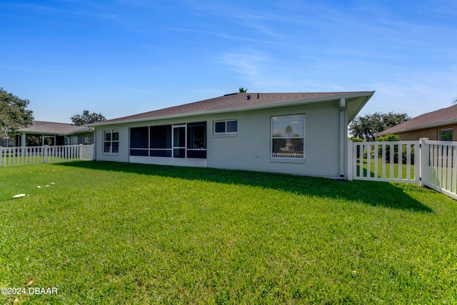 back of house featuring a yard