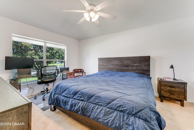 bedroom featuring light colored carpet and ceiling fan