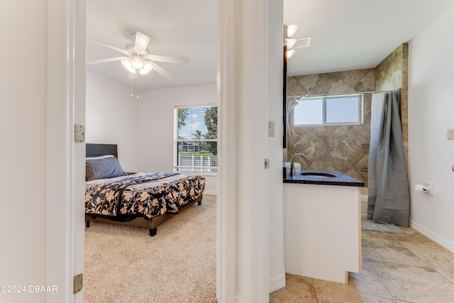 bedroom with ceiling fan and sink