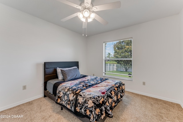 bedroom with ceiling fan and light colored carpet