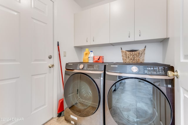 washroom with cabinets and independent washer and dryer