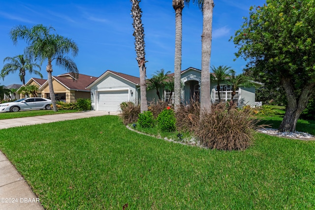 view of front of property with a front yard and a garage