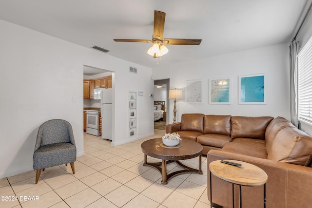 tiled living room with ceiling fan