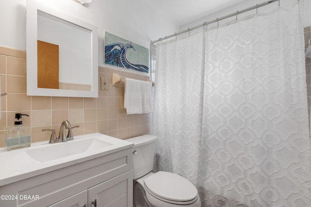 bathroom featuring toilet, tile walls, curtained shower, tasteful backsplash, and vanity