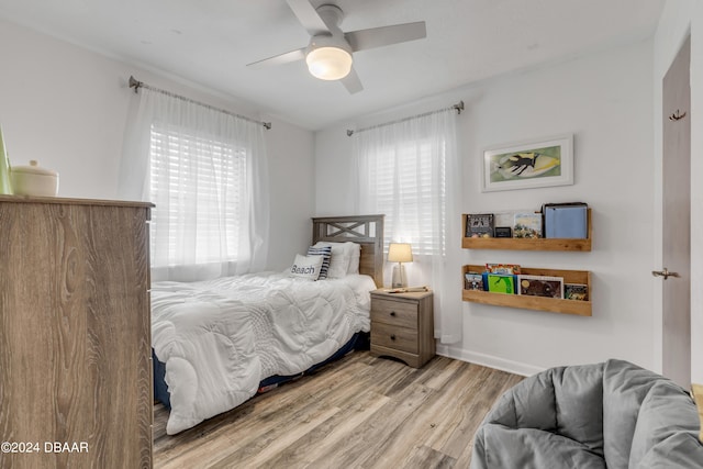 bedroom with light hardwood / wood-style floors and ceiling fan