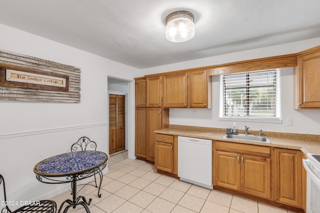 kitchen with sink, white appliances, and light tile patterned floors