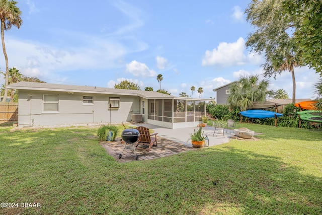 back of property with cooling unit, a patio area, a sunroom, and a yard