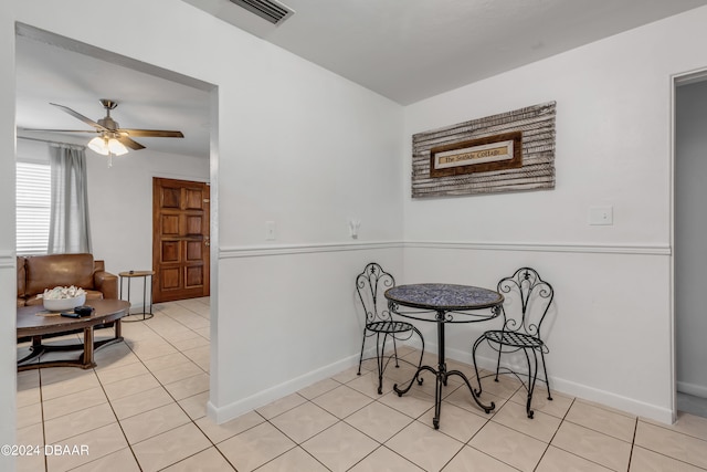 tiled dining space featuring ceiling fan