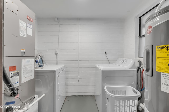 laundry room featuring washing machine and clothes dryer, heating unit, and electric water heater