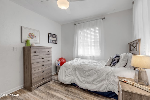 bedroom with hardwood / wood-style flooring and ceiling fan