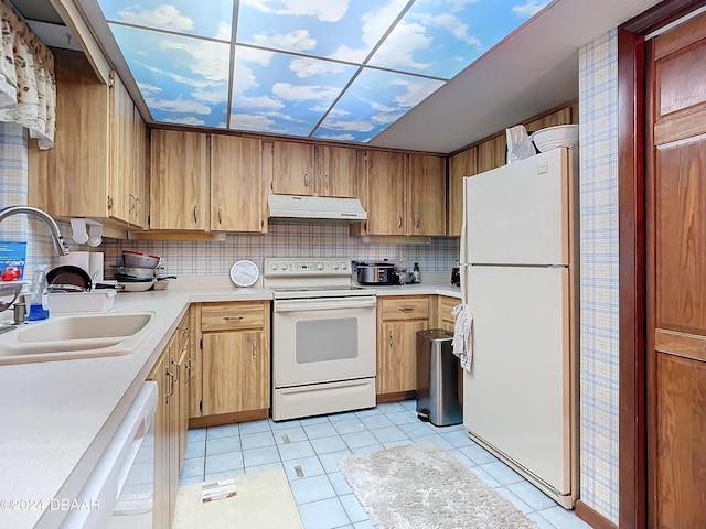 kitchen with white appliances, sink, light tile patterned flooring, and tasteful backsplash