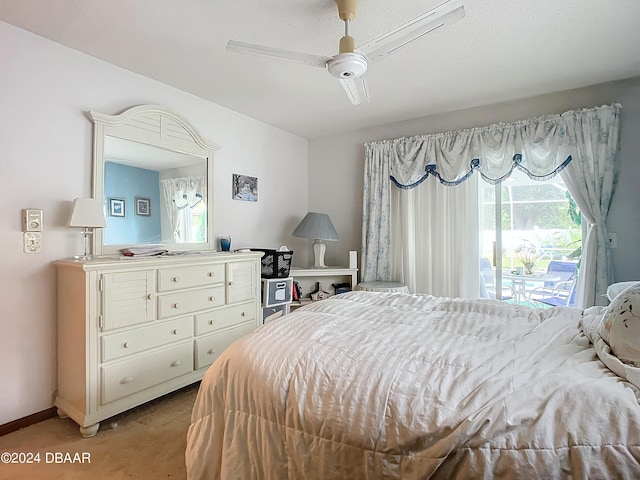 carpeted bedroom with access to exterior, a textured ceiling, and ceiling fan