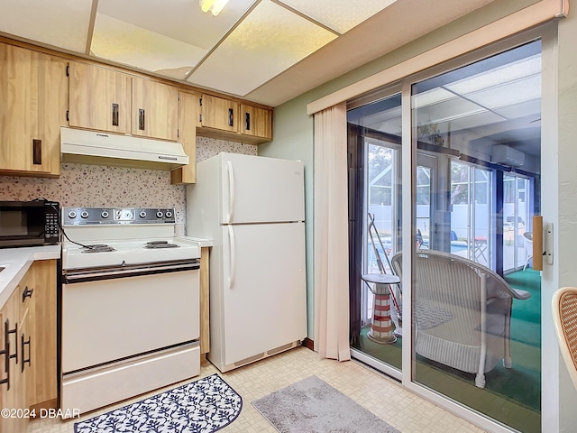 kitchen featuring light brown cabinets, white appliances, and a wall mounted AC