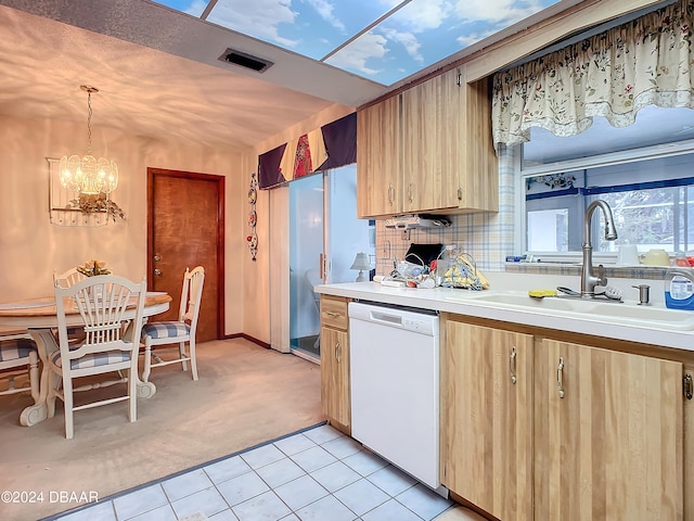 kitchen featuring decorative light fixtures, white dishwasher, decorative backsplash, sink, and light colored carpet