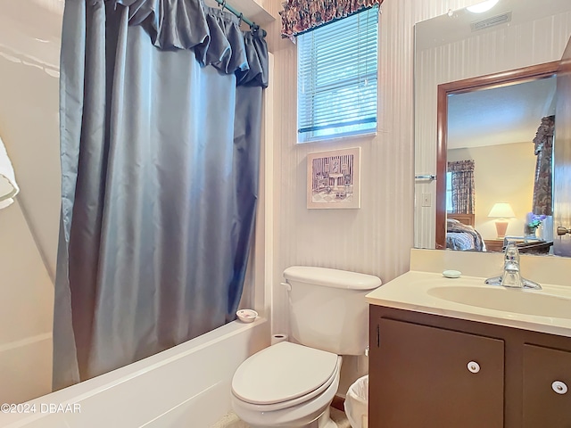 full bathroom featuring vanity, toilet, and shower / bath combination with curtain