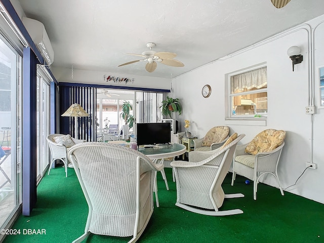 living room featuring an AC wall unit, ceiling fan, and carpet floors