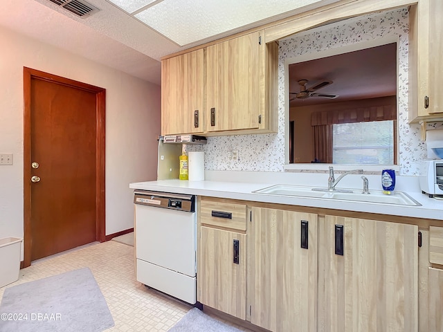 kitchen with dishwasher, light brown cabinets, sink, and ceiling fan