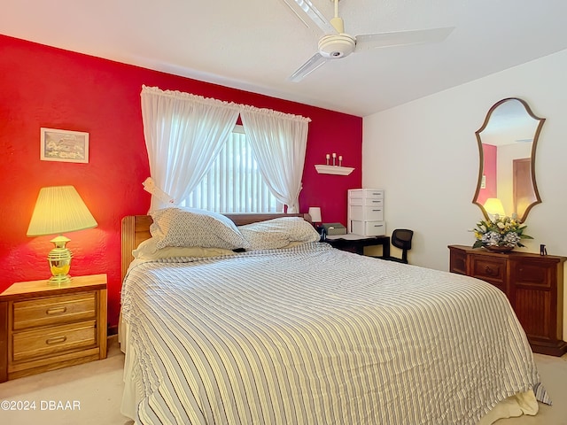 bedroom featuring light colored carpet and ceiling fan