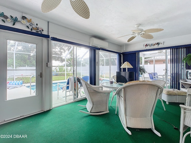 sunroom / solarium featuring ceiling fan, a wealth of natural light, and a wall mounted AC