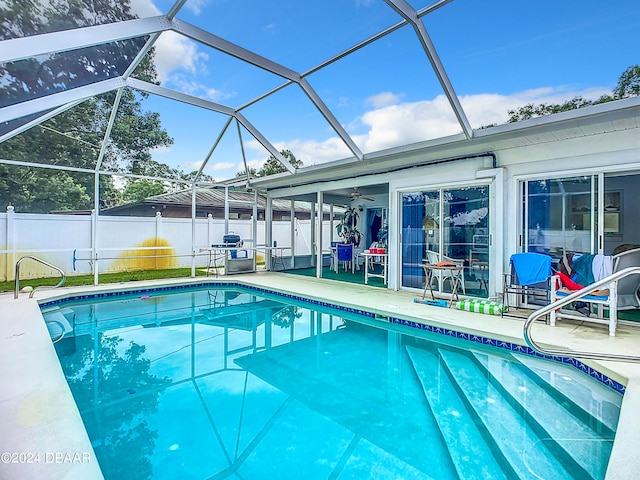 view of pool featuring ceiling fan, a lanai, and a patio area