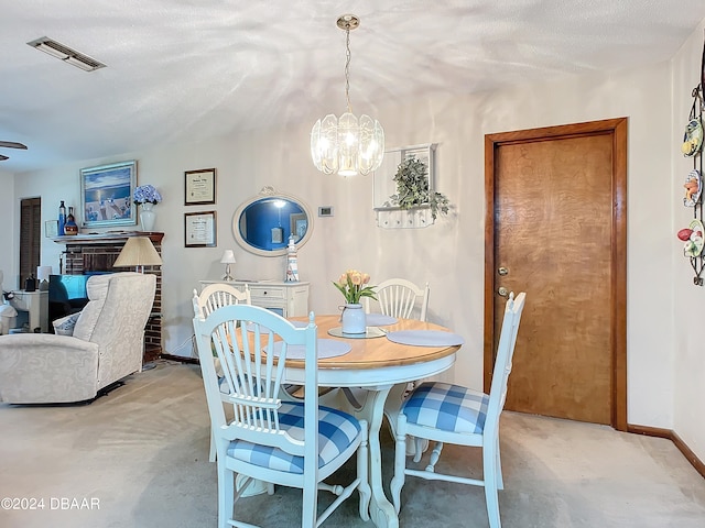 dining space featuring a chandelier and a textured ceiling