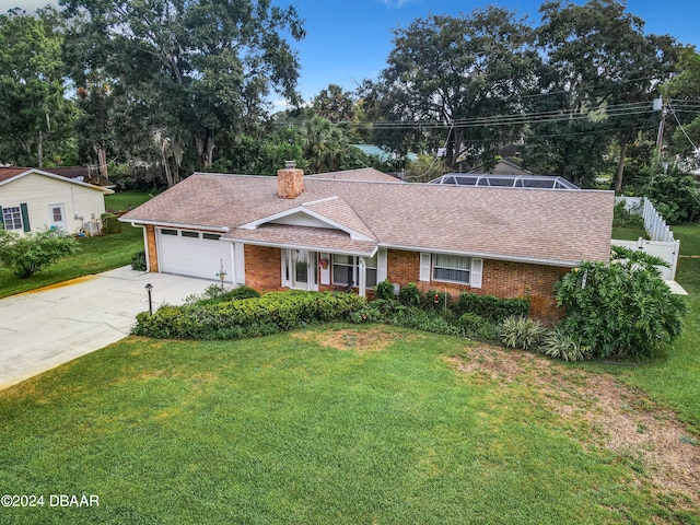 ranch-style home with a front lawn and a garage