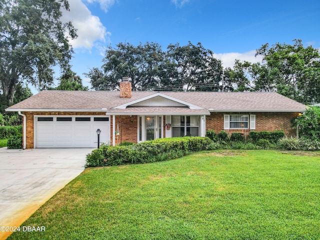 ranch-style home featuring a garage and a front lawn