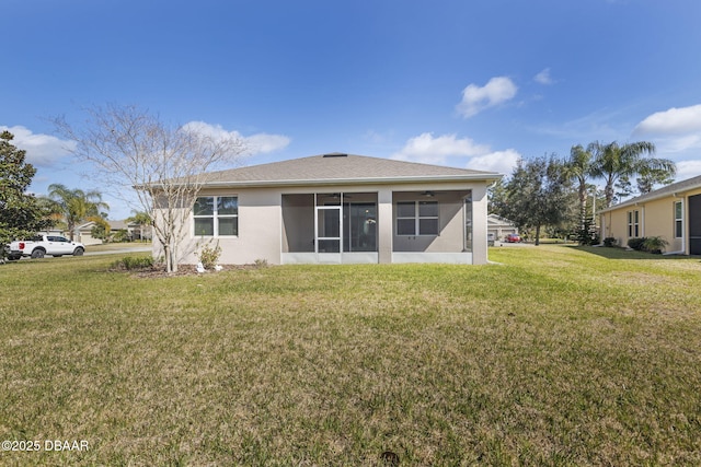 back of house featuring a sunroom and a yard