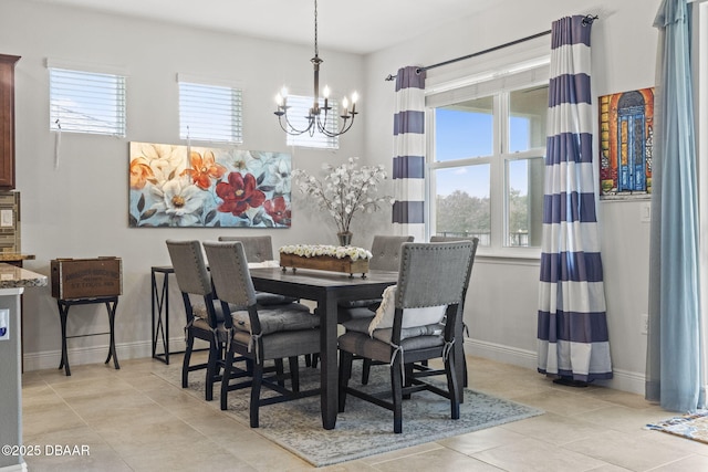 tiled dining space with a notable chandelier and a wealth of natural light