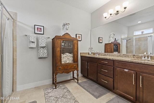 bathroom with tile patterned flooring, vanity, and walk in shower