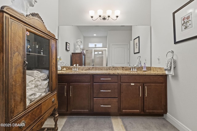 bathroom featuring vanity and a shower with shower door