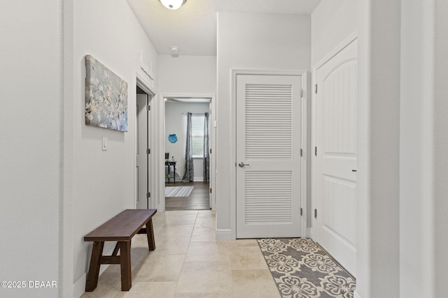 hallway featuring light tile patterned floors