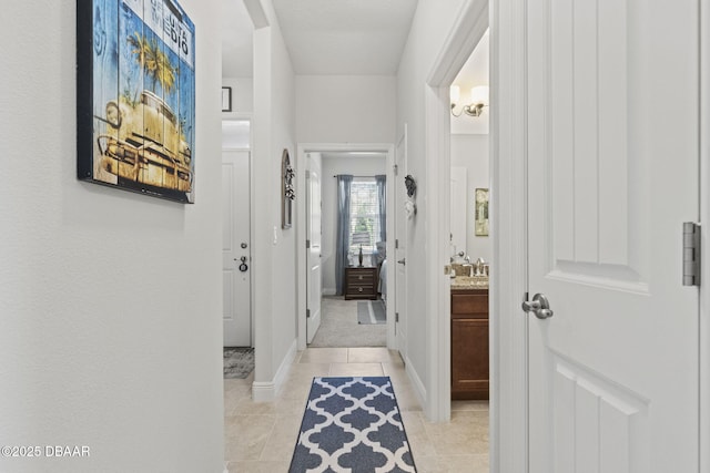 corridor featuring light tile patterned floors