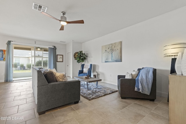 tiled living room with ceiling fan