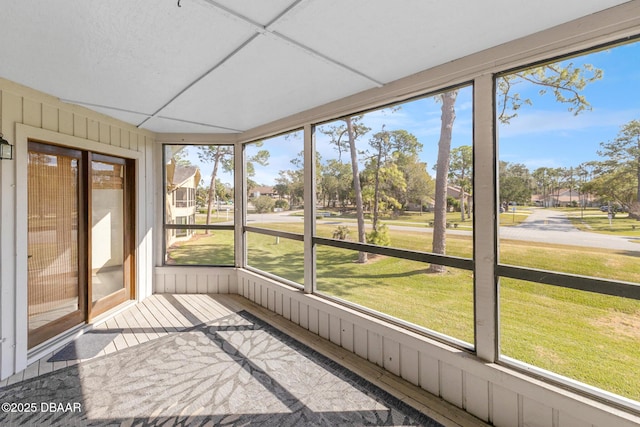 unfurnished sunroom with a drop ceiling