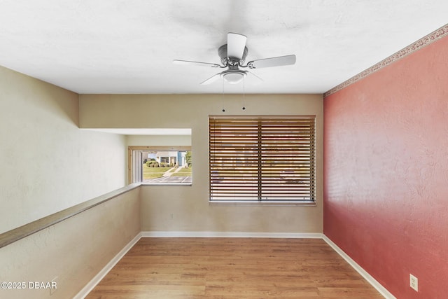 empty room featuring ceiling fan and light hardwood / wood-style floors