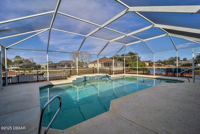 view of pool featuring a lanai, a residential view, a fenced in pool, and a patio