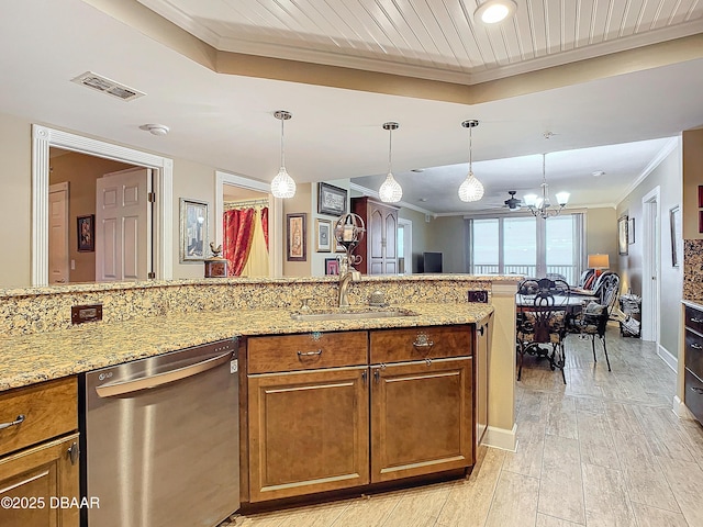 kitchen with sink, dishwasher, decorative light fixtures, and light stone countertops