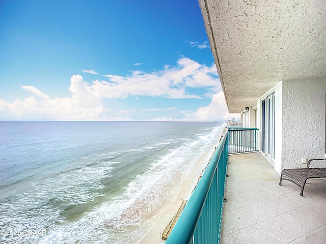 balcony with a view of the beach and a water view