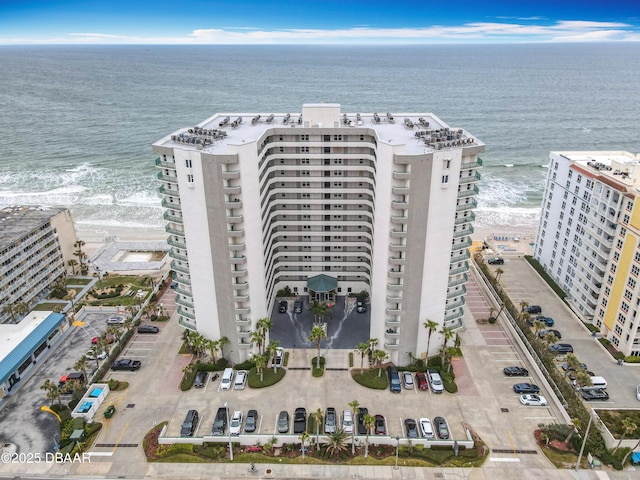 drone / aerial view featuring a beach view and a water view