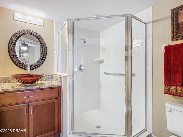 bathroom with toilet and an enclosed shower