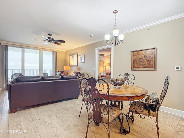 dining room with ceiling fan with notable chandelier, light wood-type flooring, and ornamental molding