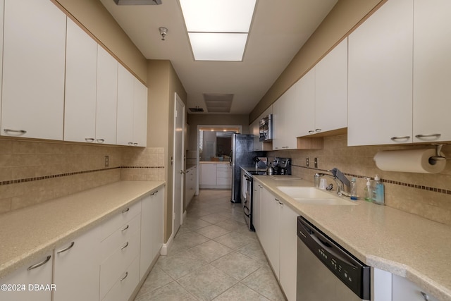 kitchen featuring stainless steel appliances, backsplash, white cabinetry, and sink